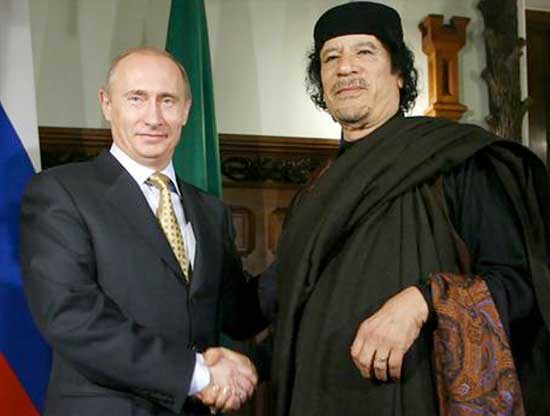 Putin with former Libyan dictator Muammar Ghaddafi. Putin lashed out at western nations and NATO after Ghaddafi's death, claiming that a NATO drone had killed the dictator.