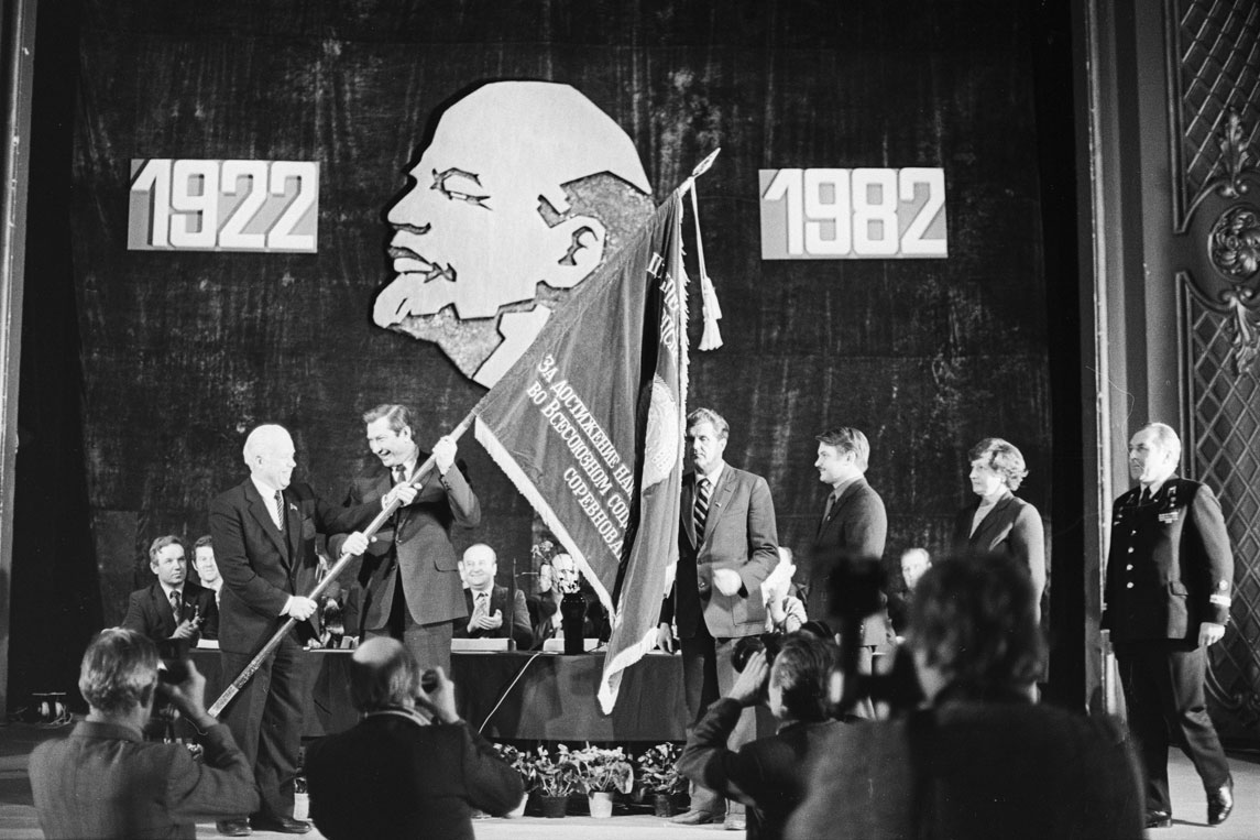 Estonian Communist Party First Secretary, Karl Vaino (left) hands a Communist Party anniversary flag to members of the Tallinn Communist Party in 1982.